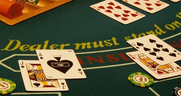 table de blackjack avec des cartes et des jetons dessus